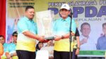 Kadispora Kepri, Muhammad Ikhsan, menyerahkan Piala bergilir POPDA Kepri kepada Gubernur Kepulauan Riau, Ansar Ahmad