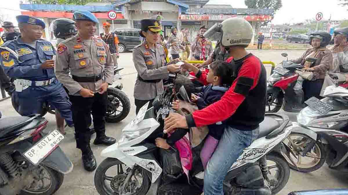 Kapolres Bintan, AKBP Yunita Stevani, membagikan tiket mudik gratis kepada pemudik kendaraan roda dua yang akan melakukan perjalanan melalui Pelabuhan ASDP Tanjung Uban